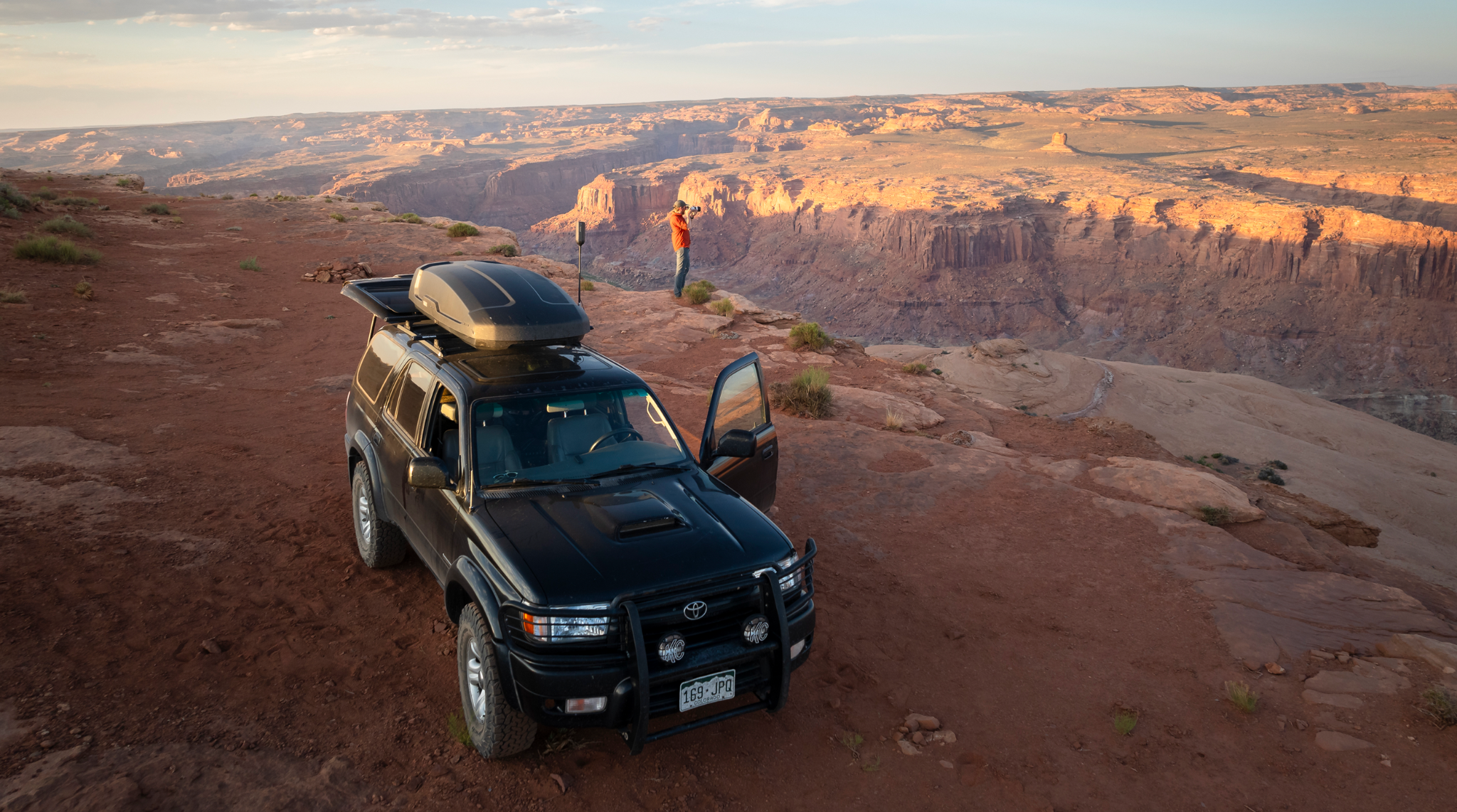 Adventure vehicle overlooking a desert canyon