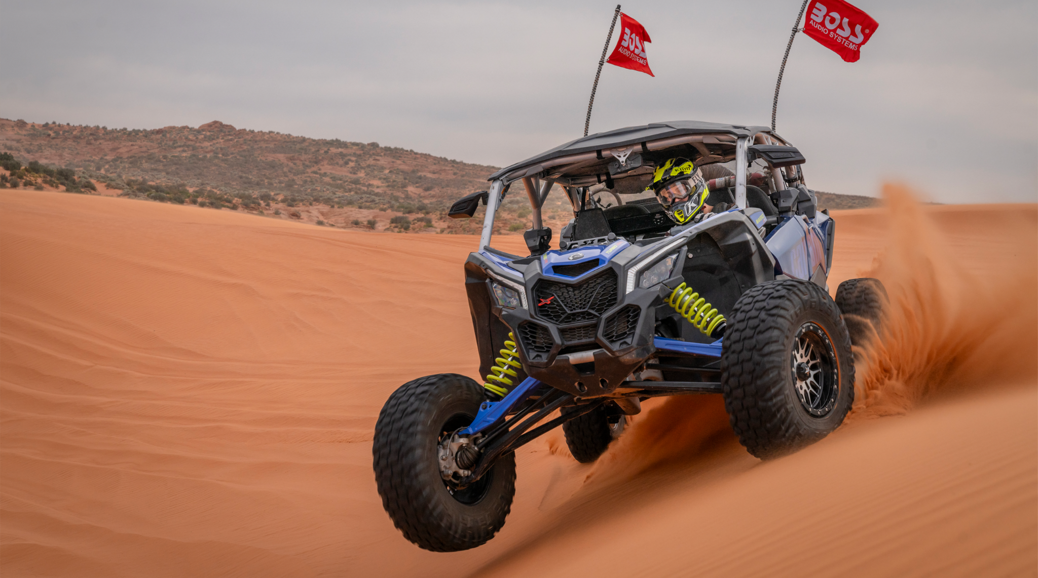 BOSS Audio-equipped off-road vehicle racing through sand dunes