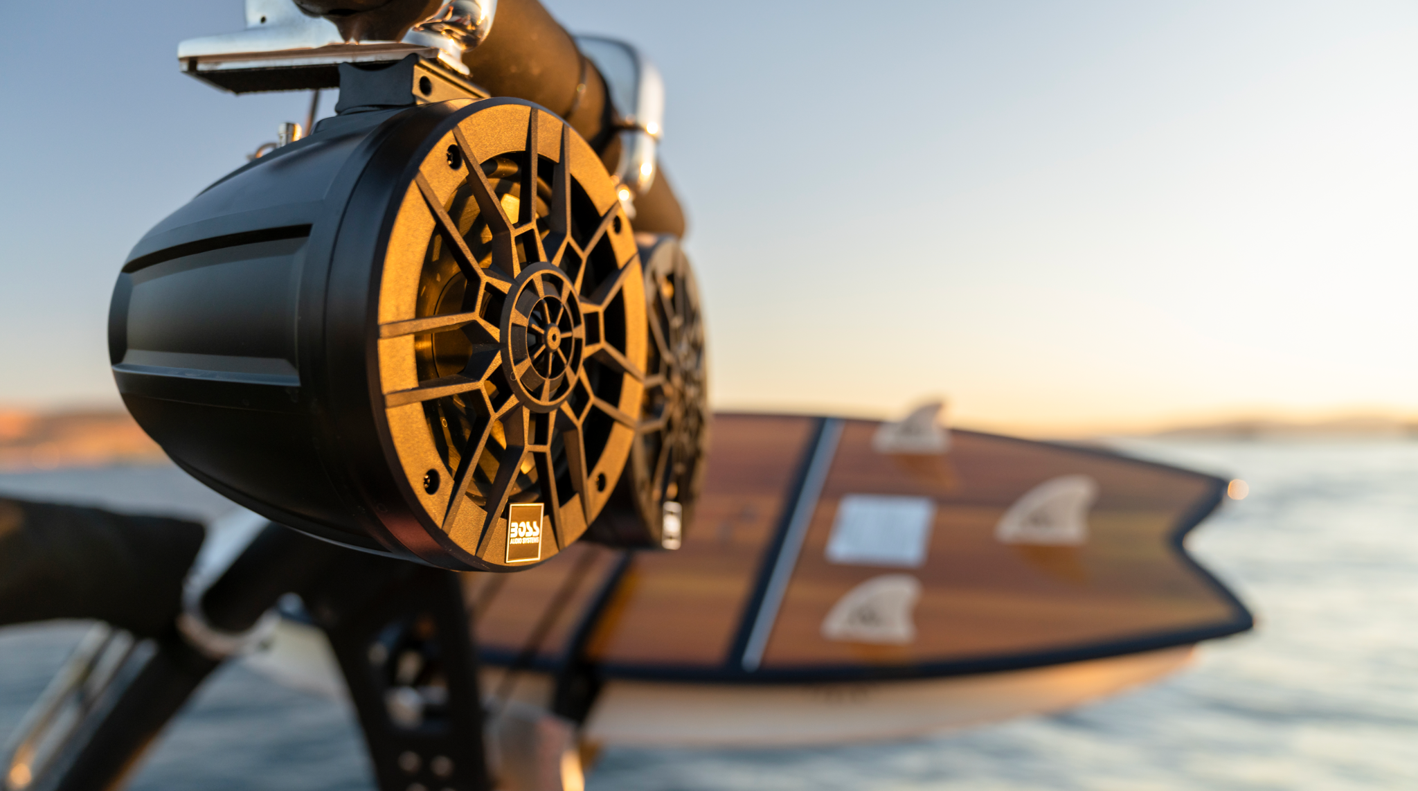 BOSS marine speakers beside surfboards