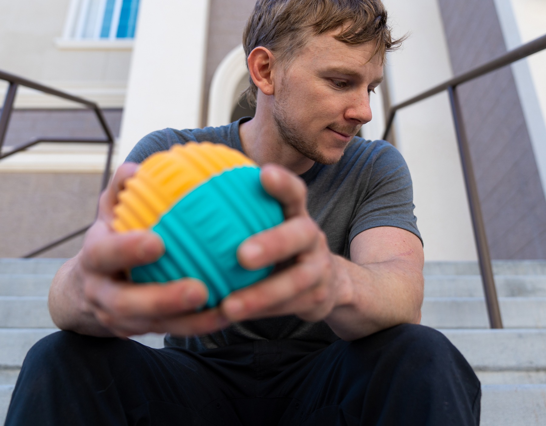 Athlete holding a colorful Njoie vibrating roller