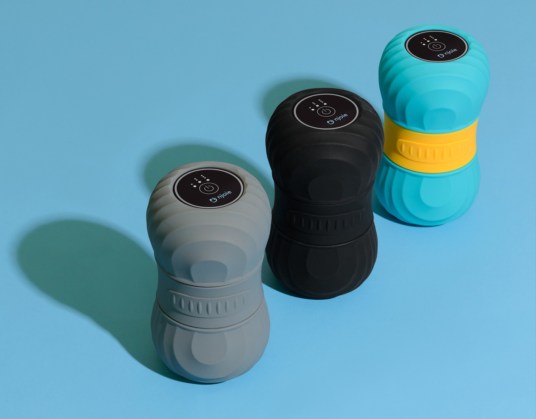 Three Njoie vibrating rollers on a blue background